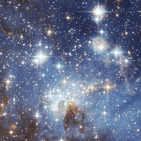 a field of bright stars and dust clouds in the Large Magellanic Cloud, photographed by the Hubble Space Telescope, courtesy Wikipedia