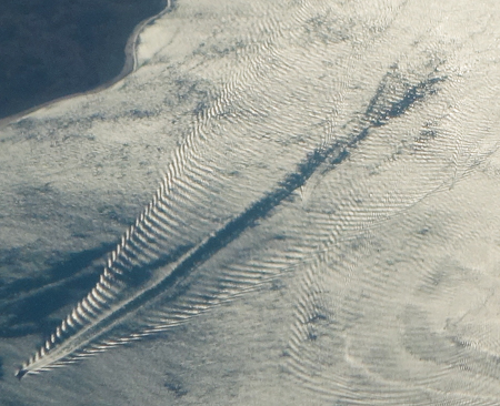 closeup of boat wakes and wave interference